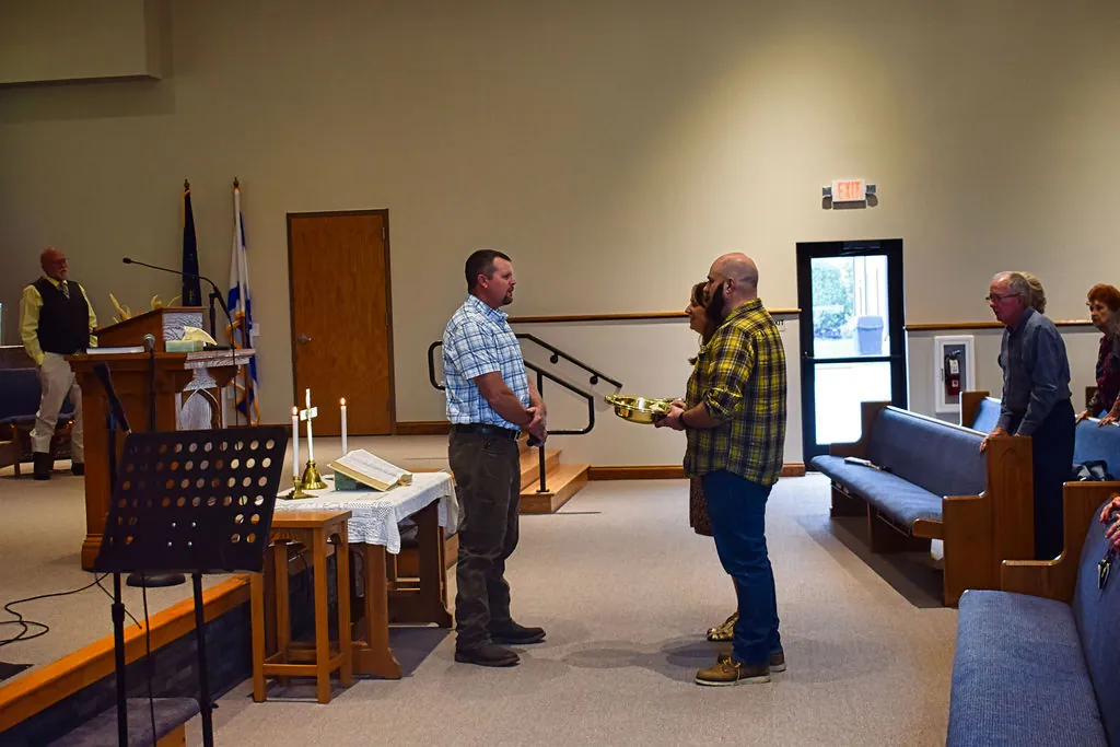 Ushers bringing the offering plates to the front of the sanctuary