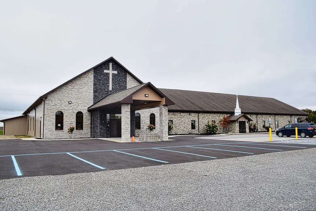 The Roseville Independent Chapel campus on Route 322 — the new stone sanctuary in front, the original chapel and steeple behind