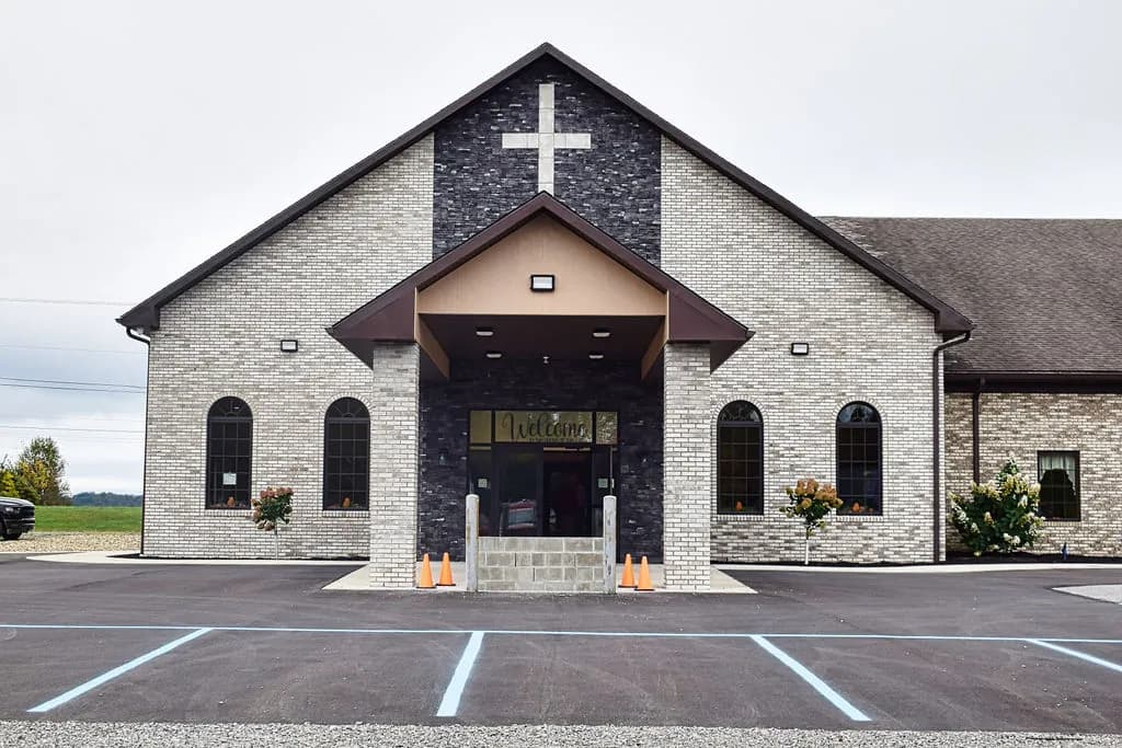 The front entrance of Roseville Independent Chapel in Brookville, PA, a white cross on the stone gable