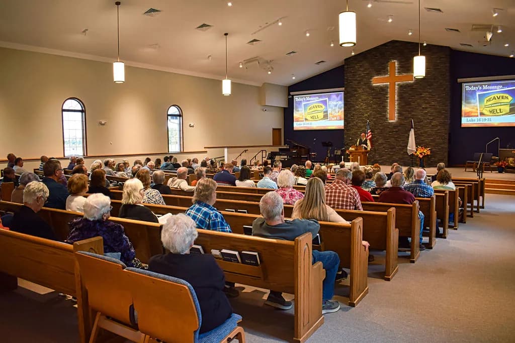 The congregation seated in the oak pews of the sanctuary on a Sunday morning