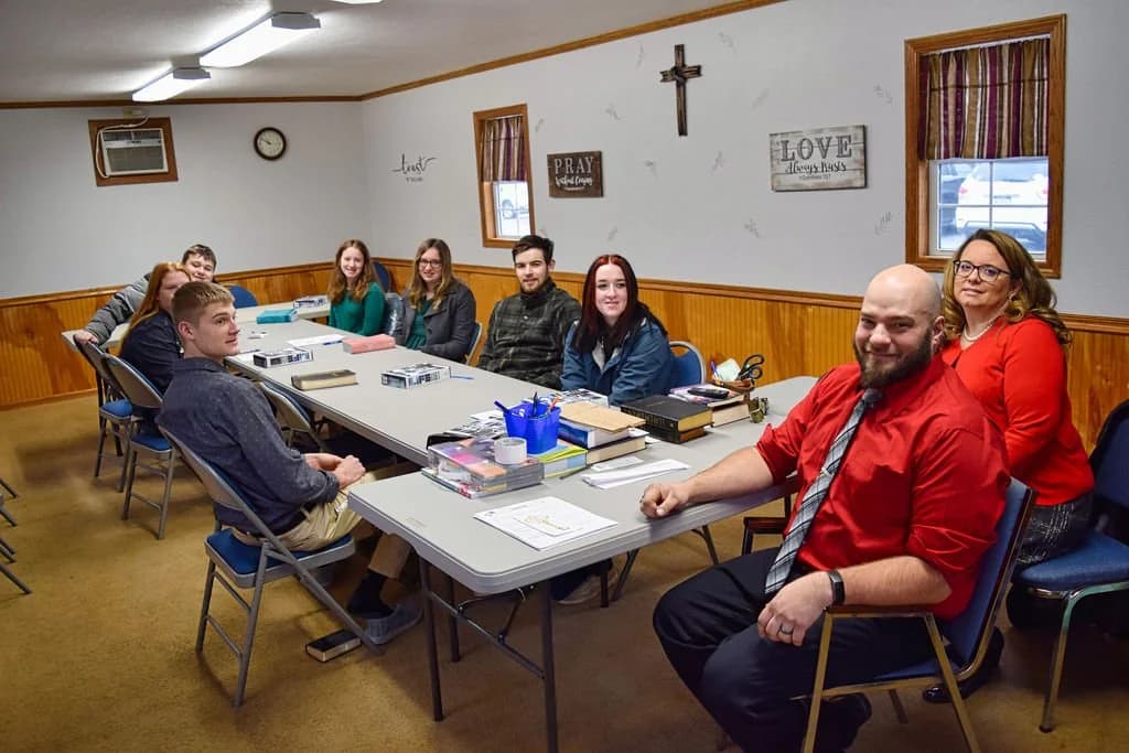 An adult Sunday School class seated at long tables