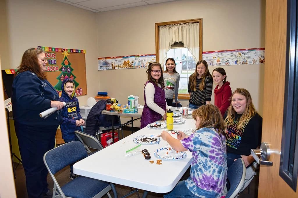 Children and young people in a Sunday School classroom with a teacher